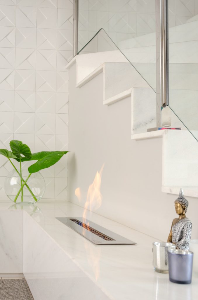 white marble fireplace into a living room